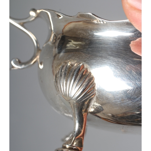 148 - A GEORGE II SILVER SAUCEBOAT by Andrew Killick, London 1751, the oval bowl with everted cut rim, aca... 