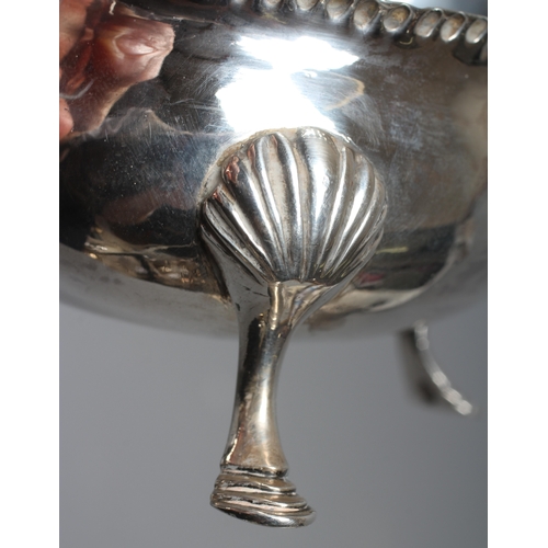 158 - AN EARLY GEORGE III SILVER SAUCEBOAT possibly by William Kersill, London 1769, the oval bowl with cr... 