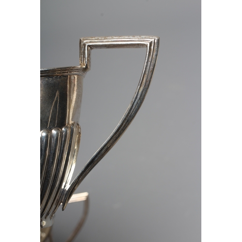 173 - A LATE VICTORIAN SILVER MILK JUG by Walker & Hall, Sheffield 1900, of semi fluted oval form with ang... 