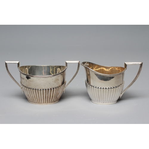 173 - A LATE VICTORIAN SILVER MILK JUG by Walker & Hall, Sheffield 1900, of semi fluted oval form with ang... 