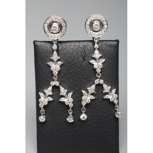 312 - A PAIR OF DIAMOND CHANDELIER EARRINGS, the target cluster hung with a double pendant husk drop to un... 