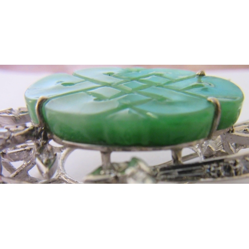 277 - A DIAMOND AND JADE FLOWER SPRAY BROOCH, the central quatrefoil jade panel incise carved and dot pier... 