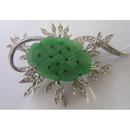 277 - A DIAMOND AND JADE FLOWER SPRAY BROOCH, the central quatrefoil jade panel incise carved and dot pier... 