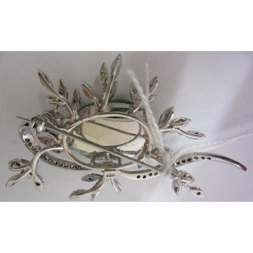 277 - A DIAMOND AND JADE FLOWER SPRAY BROOCH, the central quatrefoil jade panel incise carved and dot pier... 