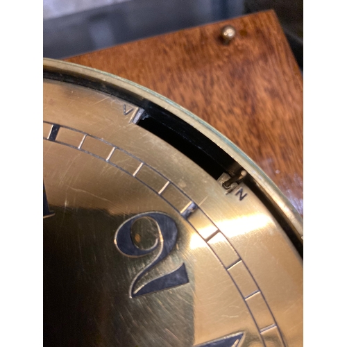 407 - A GERMAN THIRD REICH KRIEGSMARINE BRASS WALL CLOCK of bulkhead design with key opening door, brass f... 