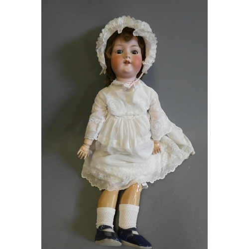 101 - A large Armand Marseille bisque socket head doll, with brown glass sleeping eyes, open mouth, teeth,... 