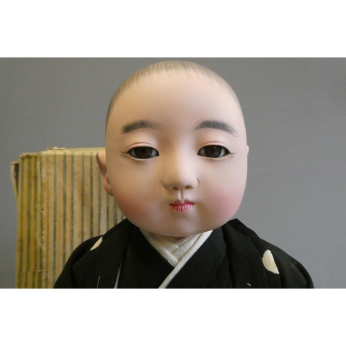 105 - A Japanese doll, with composition head, glass fixed eyes, composition lower limbs, original outfit a... 