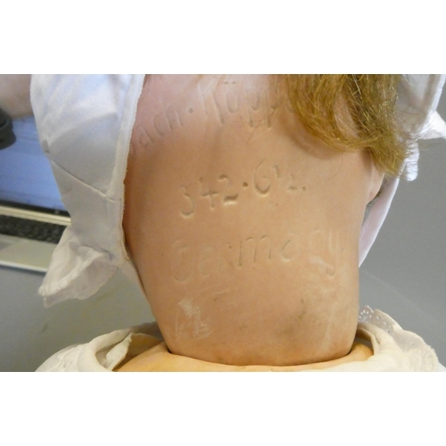 109 - A Heubach Koppelsdorf bisque socket head flirty doll, with blue glass sideways glancing eyes, metal ... 