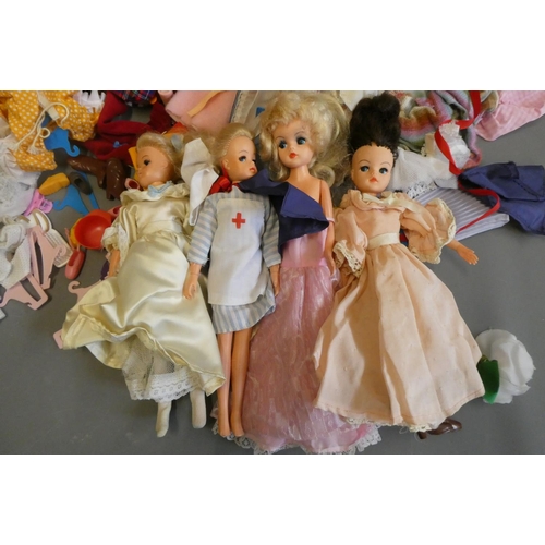 112 - Four Sindy dolls and a collection of Sindy associated clothing and accessories (qty)