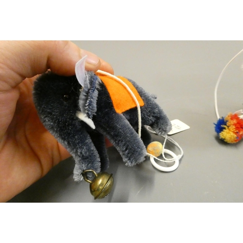 122 - Two Steiff miniature animals, comprising a white bear on all fours and an Elephant, both with bells ... 