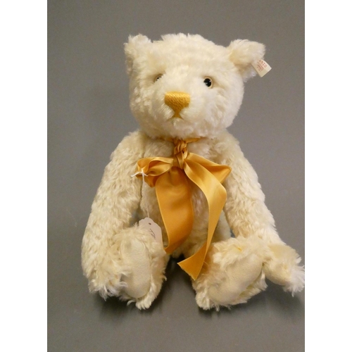 126 - A white Steiff growling teddy bear, with gold sewn nose, matching bow, felt pads, ear stud and label... 
