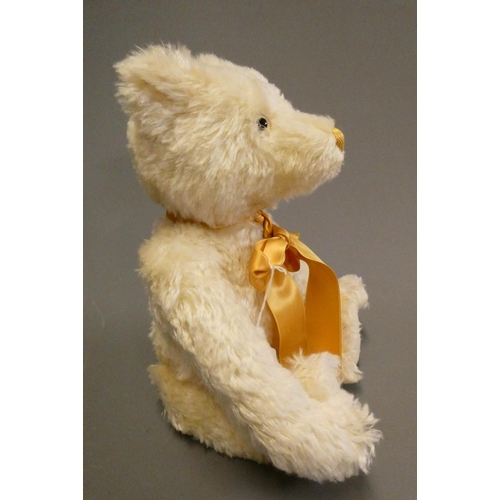 126 - A white Steiff growling teddy bear, with gold sewn nose, matching bow, felt pads, ear stud and label... 