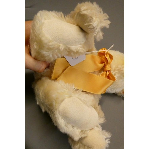 126 - A white Steiff growling teddy bear, with gold sewn nose, matching bow, felt pads, ear stud and label... 