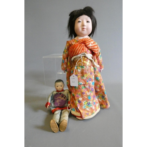 61 - Two oriental dolls comprising an 11