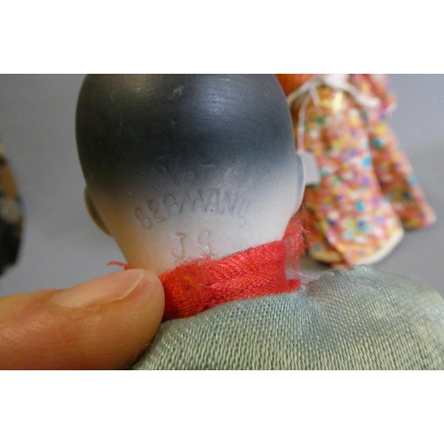 61 - Two oriental dolls comprising an 11