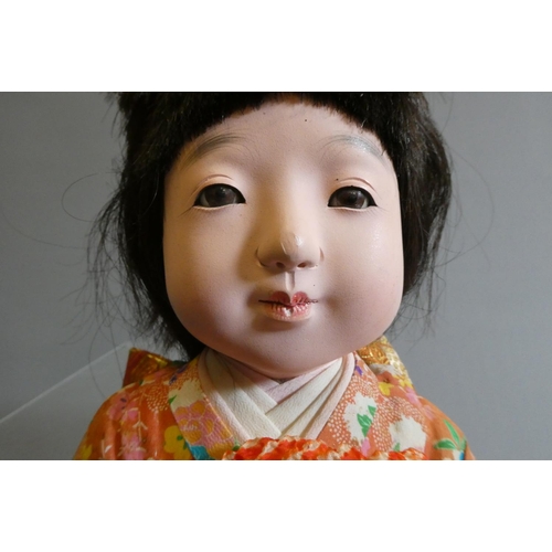 61 - Two oriental dolls comprising an 11