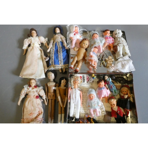 64 - A collection of vintage and antique small dolls, including a Victorian peg doll, three bisque doll's... 