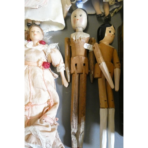 64 - A collection of vintage and antique small dolls, including a Victorian peg doll, three bisque doll's... 