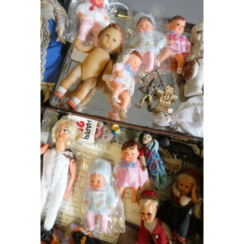 64 - A collection of vintage and antique small dolls, including a Victorian peg doll, three bisque doll's... 