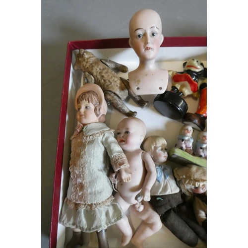 65 - A collection of vintage and antique dolls and toys, including all bisque examples, an all bisque bea... 