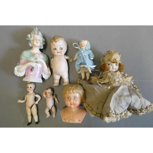 68 - Seven vintage dolls, comprising three all bisque doll's house dolls, including one with glass eyes, ... 
