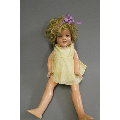69 - A Shirley Temple doll, with blue sleeping eyes, open mouth, teeth, blond wig, jointed composition bo... 