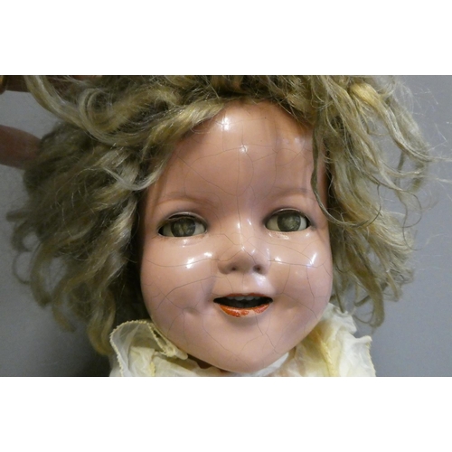 69 - A Shirley Temple doll, with blue sleeping eyes, open mouth, teeth, blond wig, jointed composition bo... 