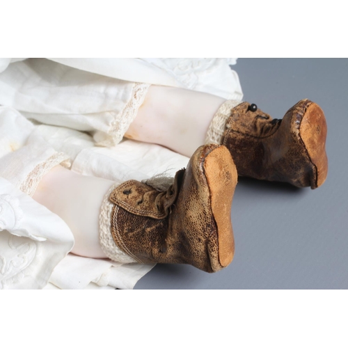 74 - A Victorian poured wax shoulder head doll, with blue glass fixed eyes, closed mouth, blond wig, fabr... 