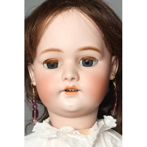 75 - A Simon & Halbig bisque socket head doll, with blue glass sleeping eyes, open mouth, teeth, pierced ... 