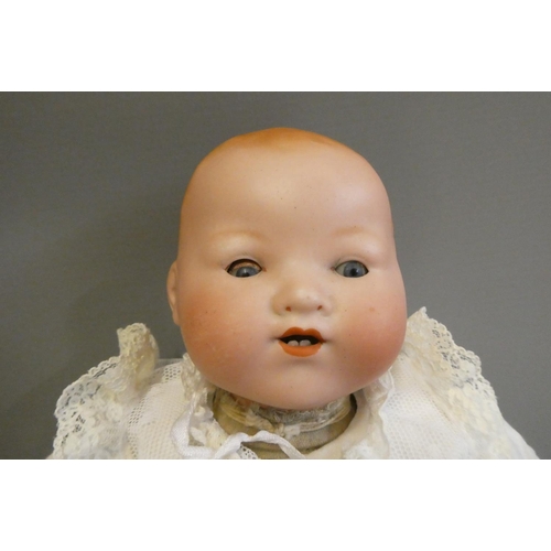 79 - A Heubach Koppelsdorf bisque socket head doll, with blue glass sleeping eyes, open mouth, teeth and ... 