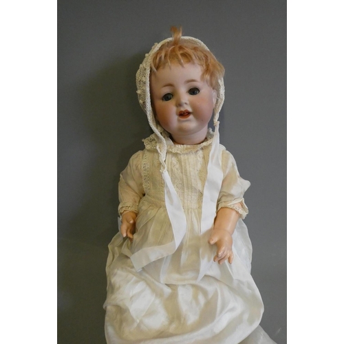 82 - A German bisque socket head character doll, with blue glass sleeping eyes, open mouth, applied top t... 