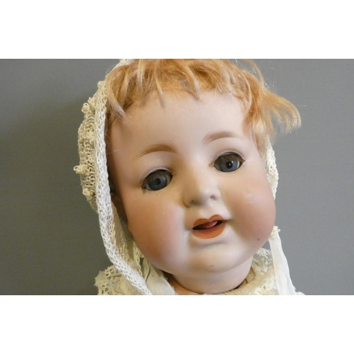 82 - A German bisque socket head character doll, with blue glass sleeping eyes, open mouth, applied top t... 