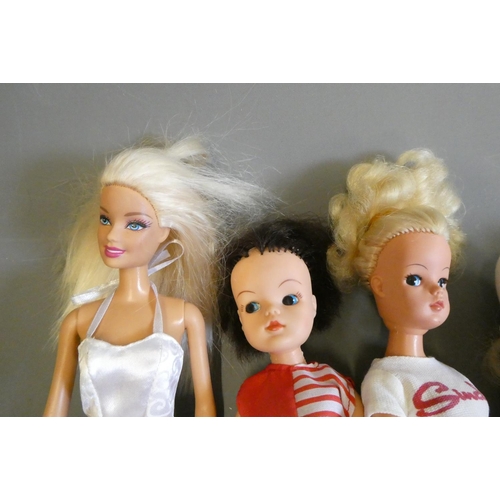 85 - Vintage dolls comprising three Sindy dolls (one with scooter), a Pedigree Sindy Paul doll, and a Bar... 