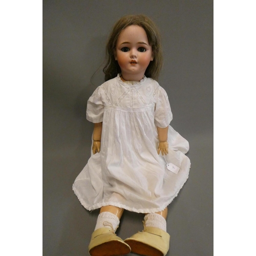 90 - A Schoenau & Hoffmeister bisque socket head doll, with blue glass sleeping eyes, open mouth, teeth, ... 