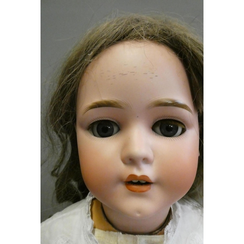 90 - A Schoenau & Hoffmeister bisque socket head doll, with blue glass sleeping eyes, open mouth, teeth, ... 