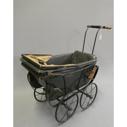 93 - A late Victorian dolls twin pram, with leatherette hood, sprung base suspended on leather straps and... 