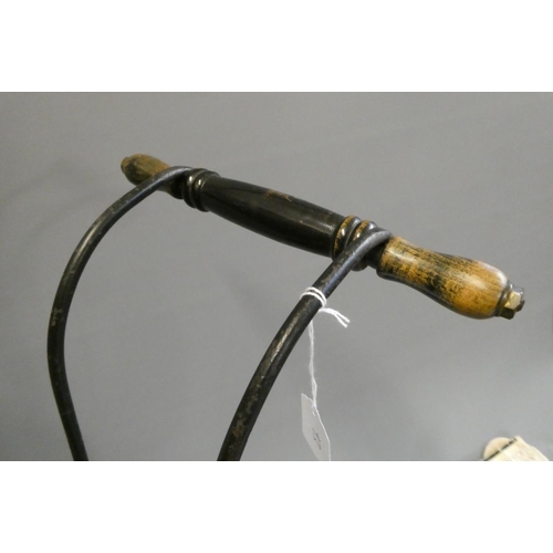 93 - A late Victorian dolls twin pram, with leatherette hood, sprung base suspended on leather straps and... 