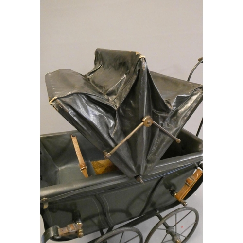 93 - A late Victorian dolls twin pram, with leatherette hood, sprung base suspended on leather straps and... 