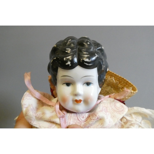 95 - A Victorian china shoulder head doll, with moulded hair, painted features, fabric body, china lower ... 