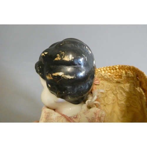 95 - A Victorian china shoulder head doll, with moulded hair, painted features, fabric body, china lower ... 