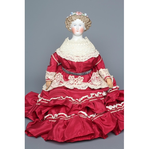 97 - A bisque shoulder head doll, possibly Dornheim, with moulded hair encrusted with flowers, painted fe... 