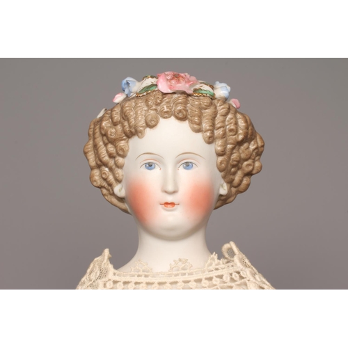 97 - A bisque shoulder head doll, possibly Dornheim, with moulded hair encrusted with flowers, painted fe... 