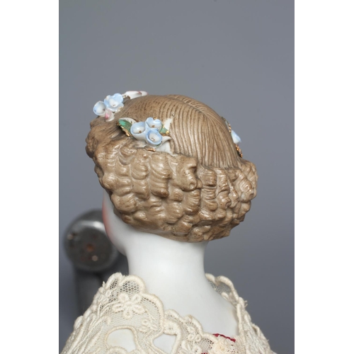 97 - A bisque shoulder head doll, possibly Dornheim, with moulded hair encrusted with flowers, painted fe... 