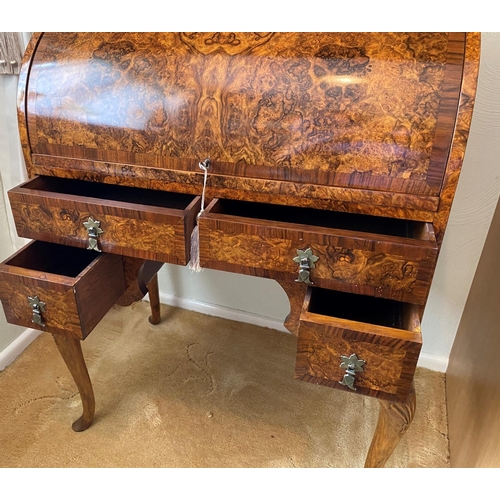 115 - figured walnut cylinder desk on carved gabriole legs with a fitted interior, inkwells with original ... 