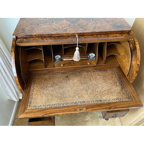 115 - figured walnut cylinder desk on carved gabriole legs with a fitted interior, inkwells with original ... 