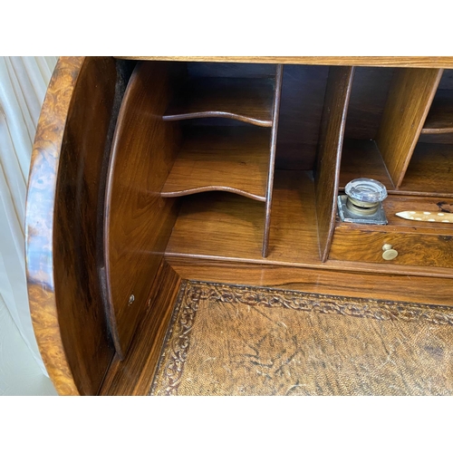 115 - figured walnut cylinder desk on carved gabriole legs with a fitted interior, inkwells with original ... 