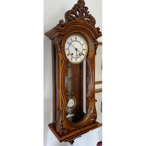 143 - 8 day spring driven wall clock circa 1885 with white porcellane dial with roman numerals, strikes th... 