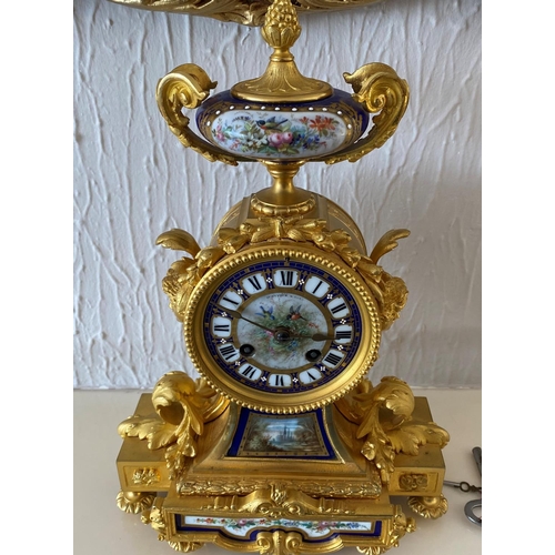 158 - A french ormolu mantel clock surmounted by a paris porcelain urn with acorn finial and acanthus leaf... 