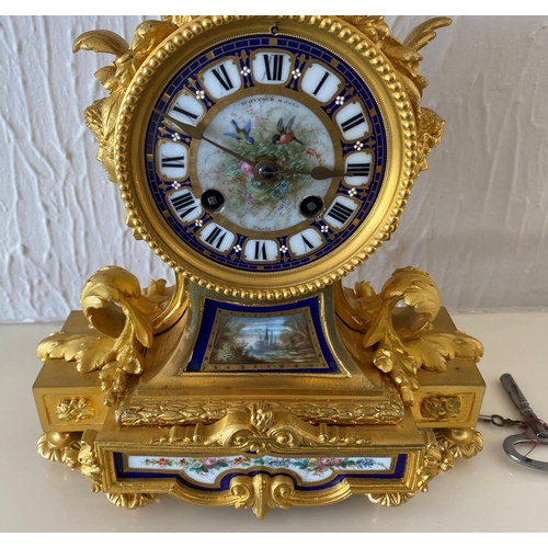 158 - A french ormolu mantel clock surmounted by a paris porcelain urn with acorn finial and acanthus leaf... 