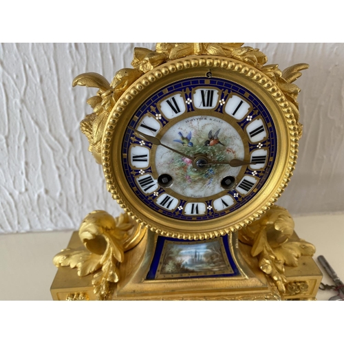 158 - A french ormolu mantel clock surmounted by a paris porcelain urn with acorn finial and acanthus leaf... 